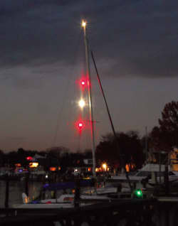 Dive boat displaying specialized lighting signals to indicate divers in the water and restricted maneuverability