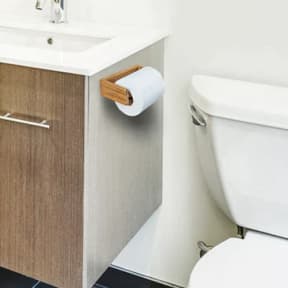 in use of Whitecap Industries Teak Toilet Tissue Rack