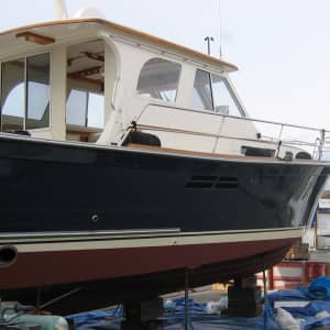 Powerboat on boat stands in the boat yard awaiting maintenance.