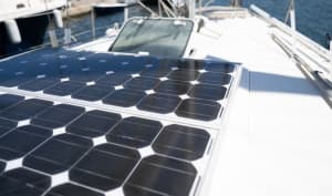 Flexible solar panels mounted on a sailboat to maximize direct sunlight exposure.