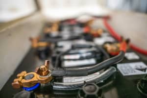 A clean, secure marine battery bank installation inside a boat compartment setup for winter storage.