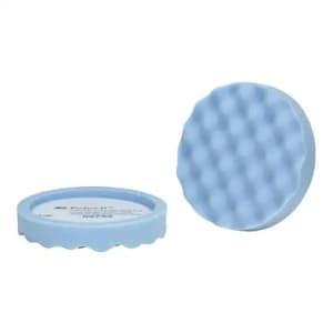 Close-up of a foam polishing pad used with an electric buffer to refine the surface after compounding